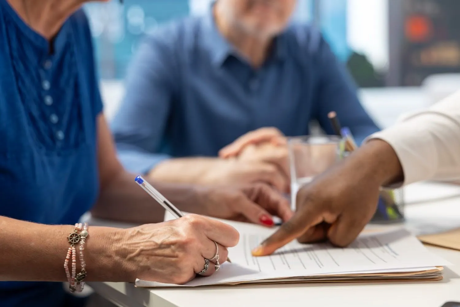 Close view of hands going through a coverage form at a desk